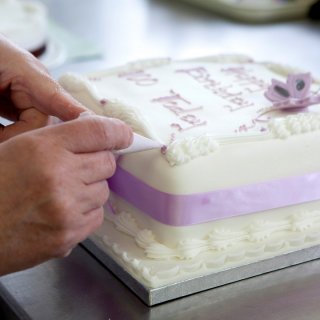 Hand written cake being hand finished